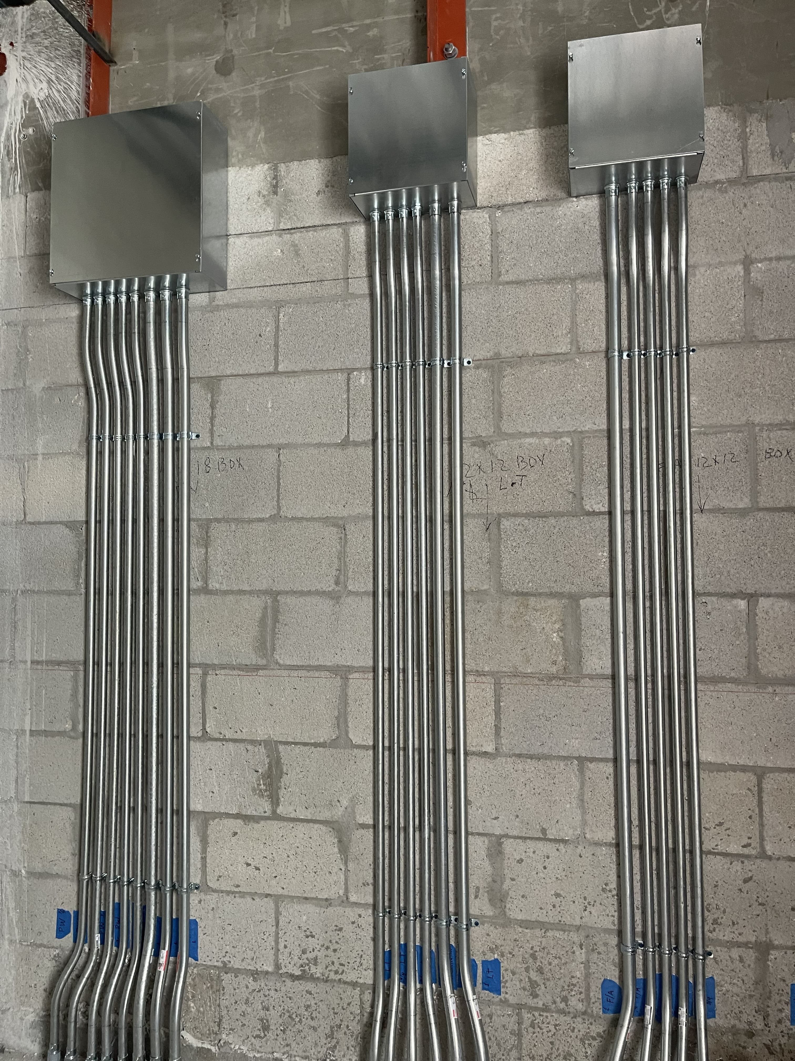 Junction boxes and conduit runs supporting branch circuit distribution