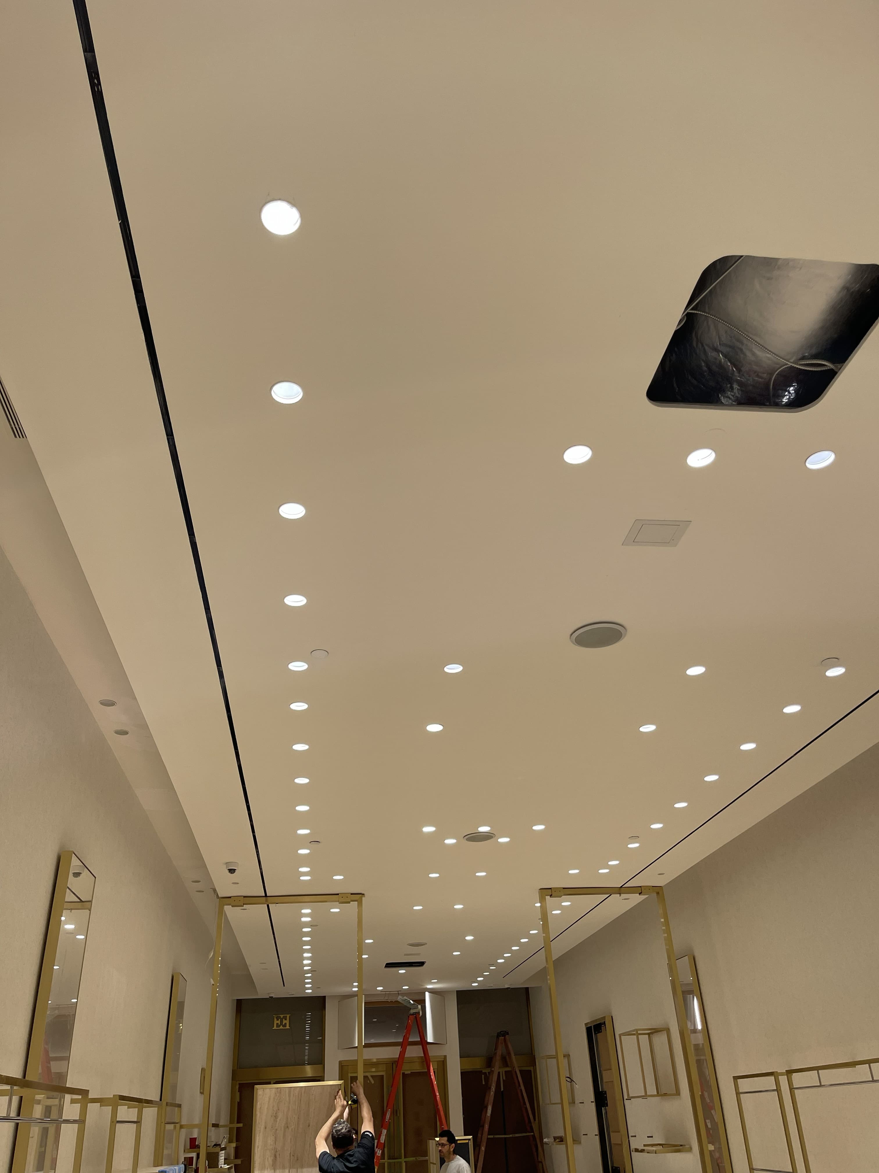 Recessed architectural lighting installation along a commercial retail corridor