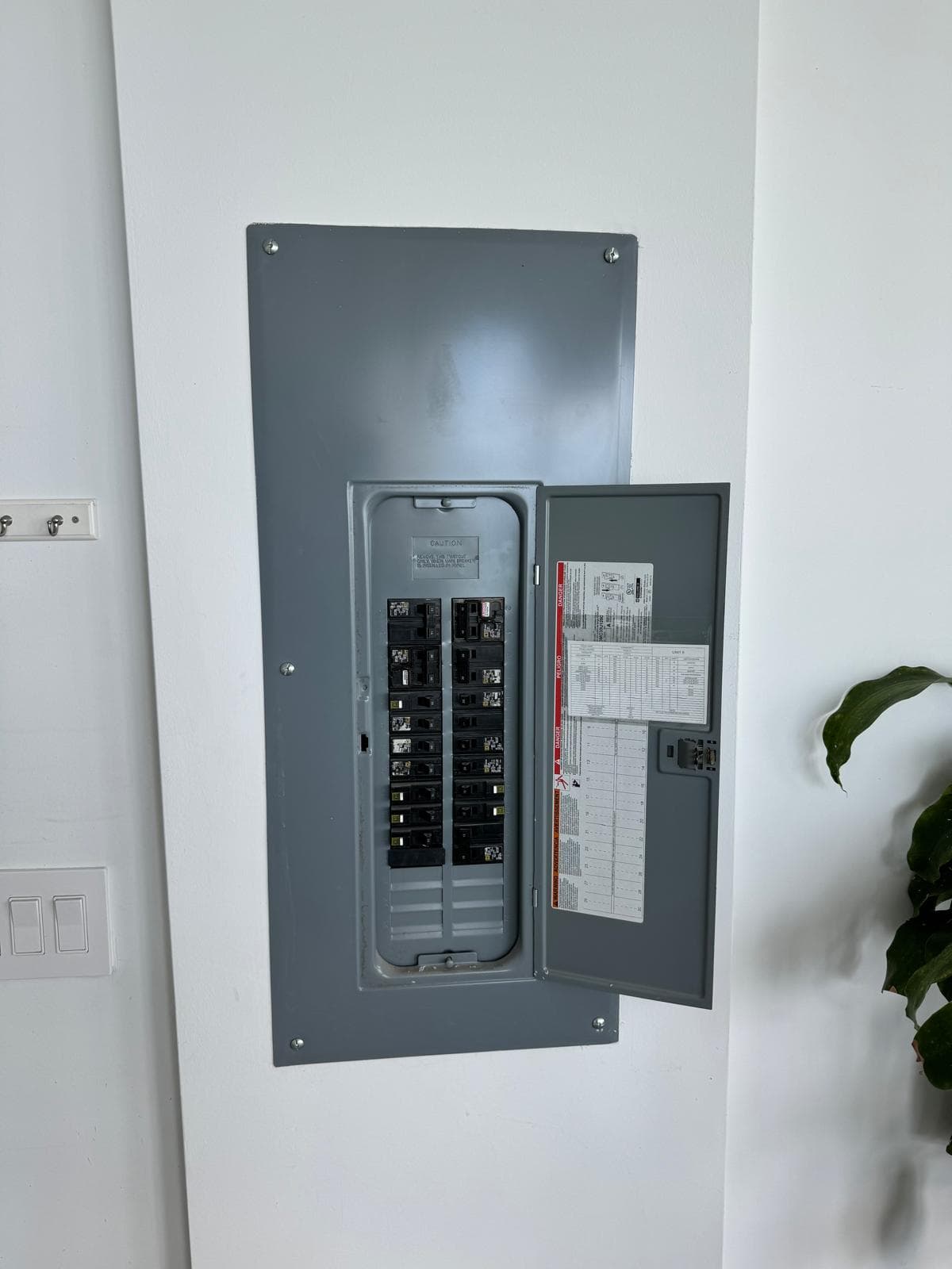 Open residential electrical panel with breakers visible, evaluated for load and capacity