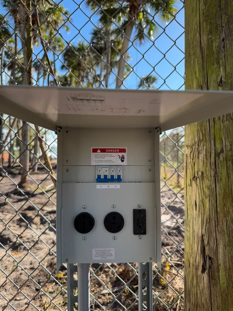 Weather-resistant outdoor power panel with 50A and 30A receptacles and GFCI protection, mounted on a post
