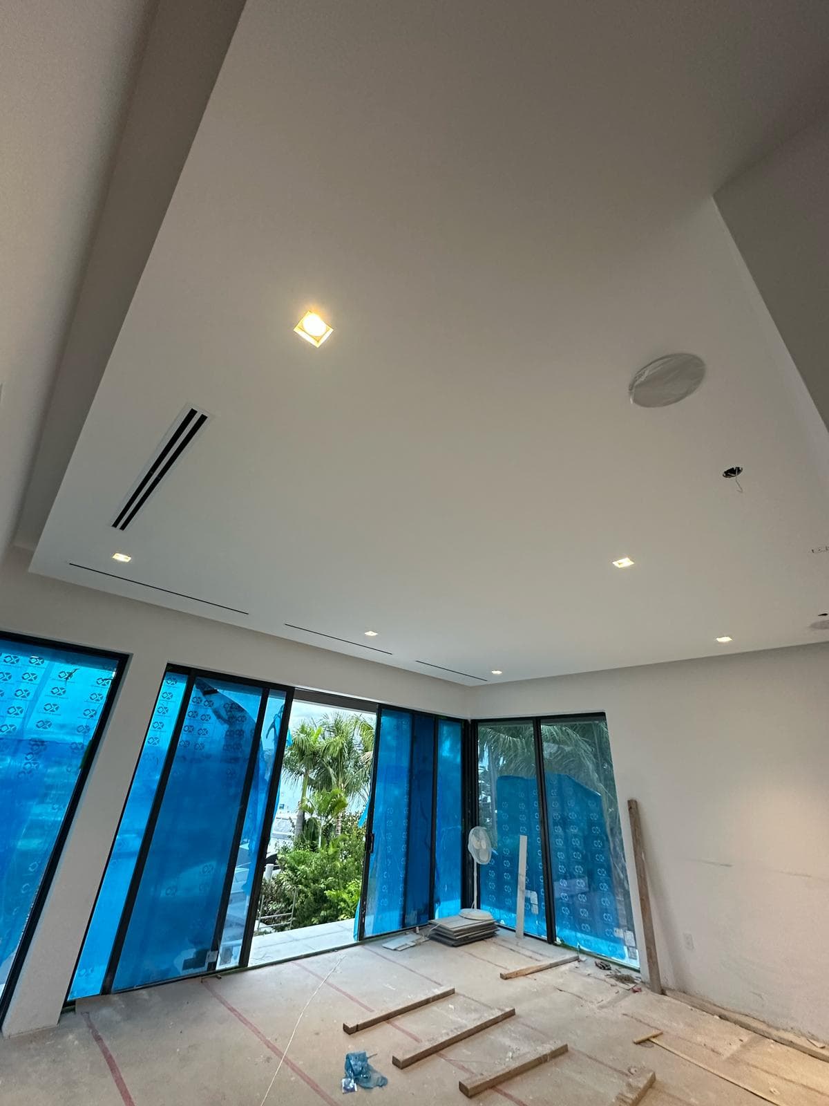 Recessed lighting installed in a vaulted ceiling ahead of paint at a new residential construction site