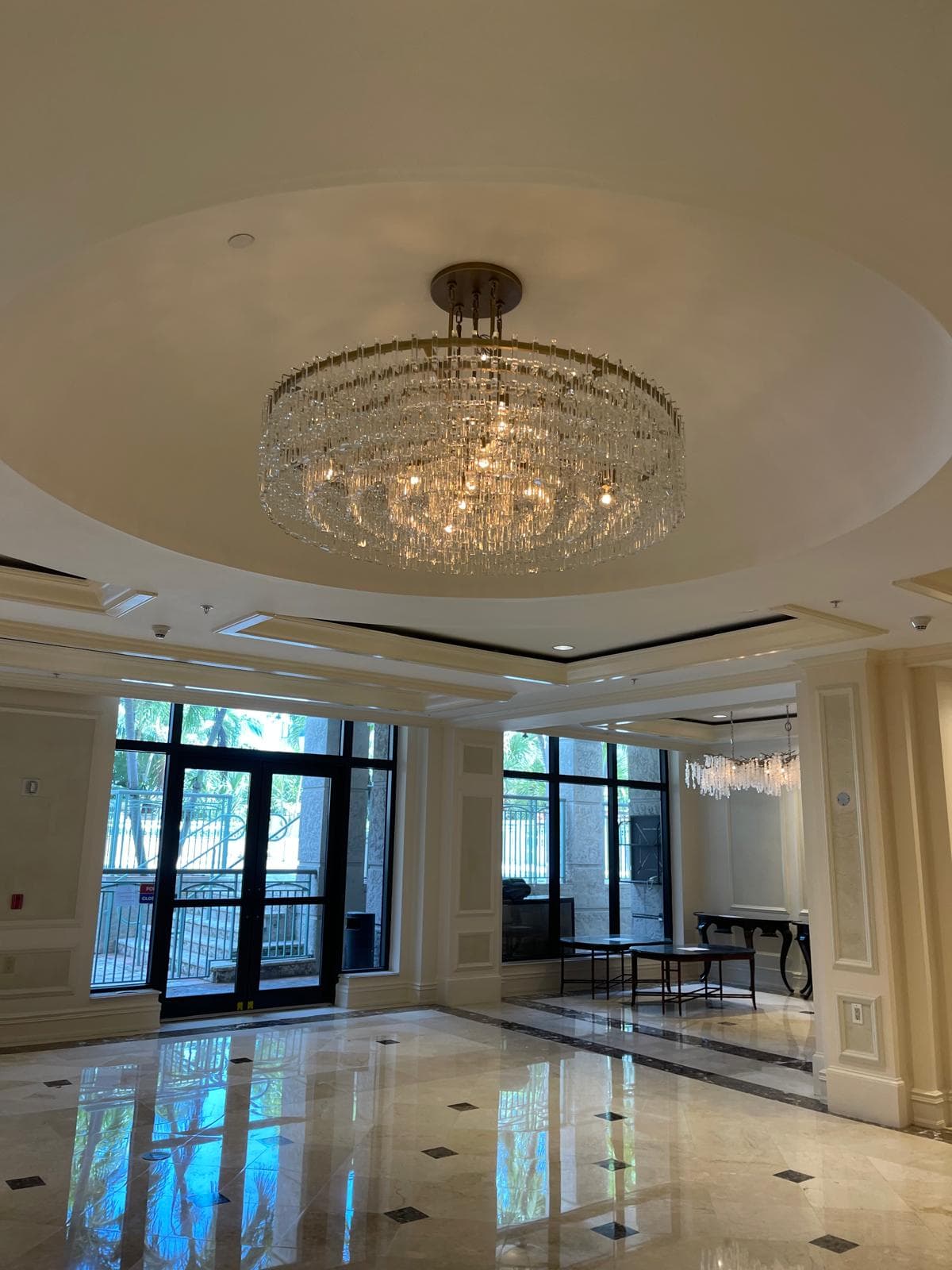 Large decorative chandelier in a high-ceilinged residential interior