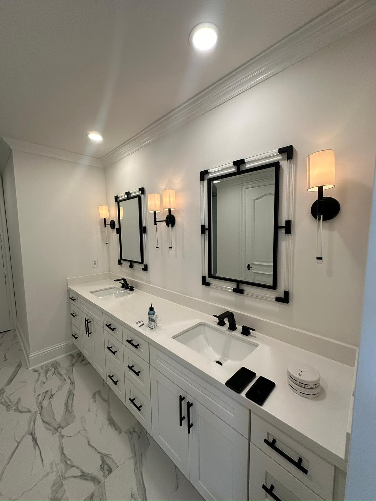Finished residential bathroom remodel with vanity lighting and mirrors