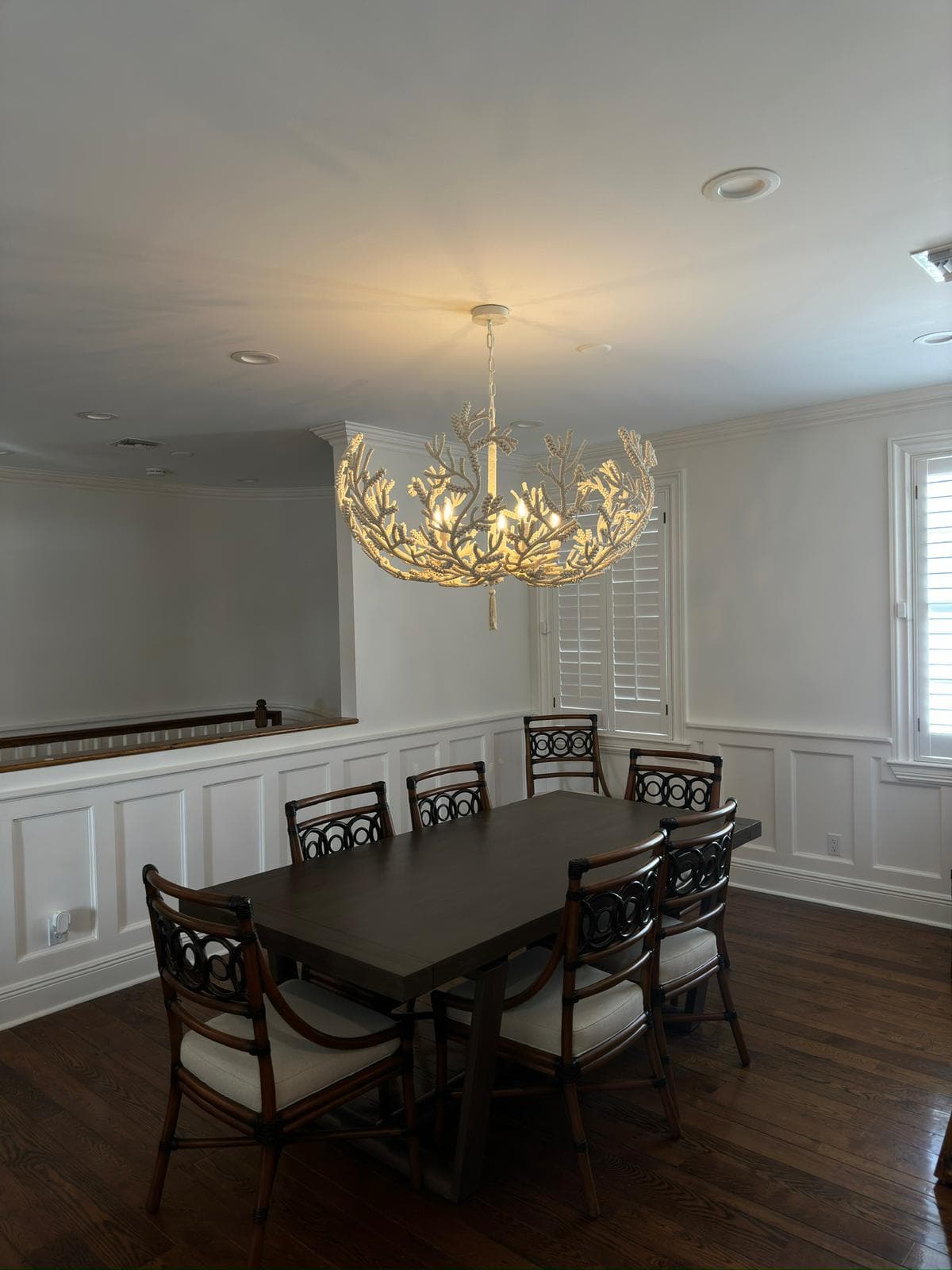 Finished residential dining room with a decorative chandelier
