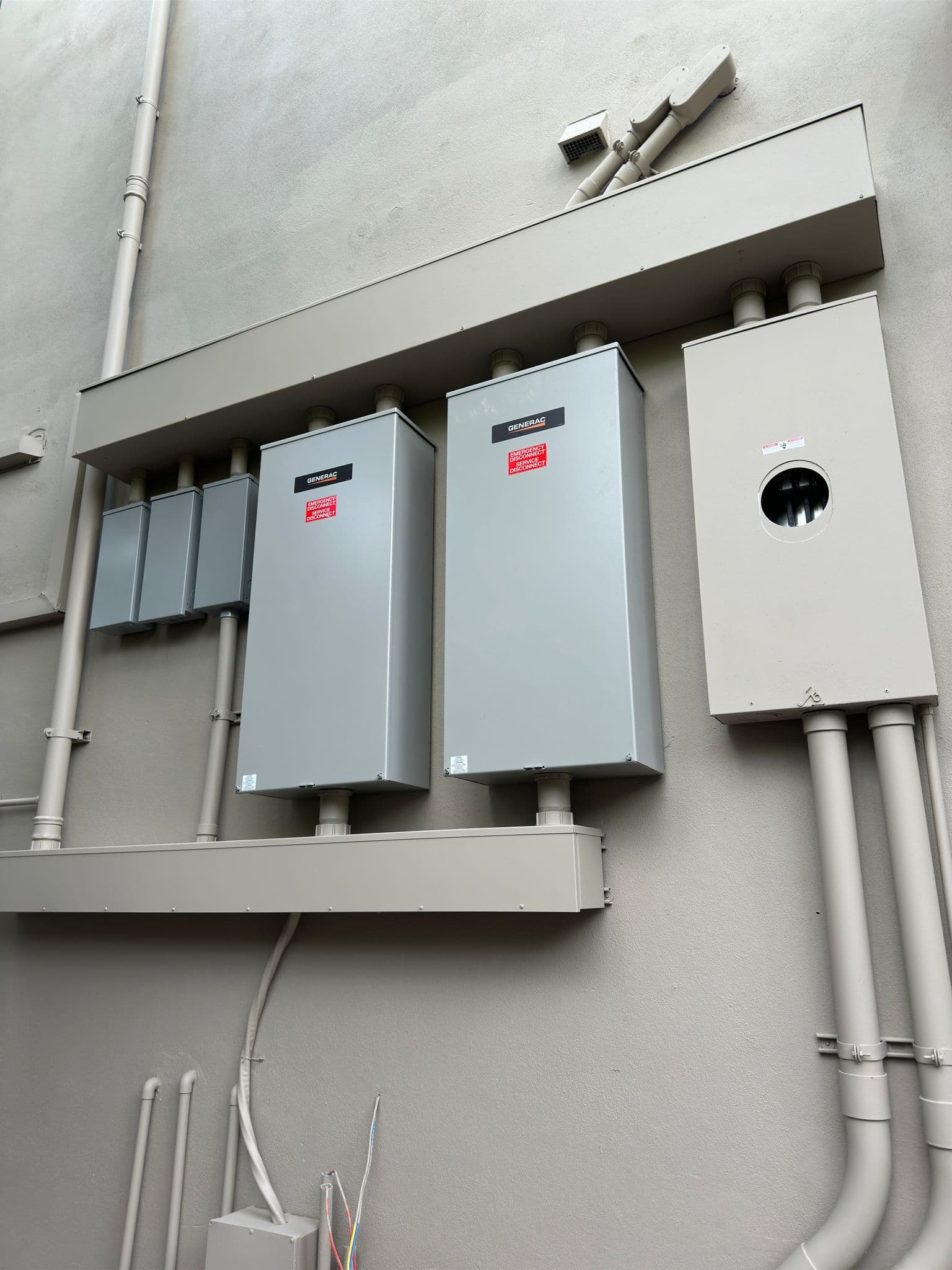 Exterior electrical disconnects, service equipment, and conduit installed on a new construction project.