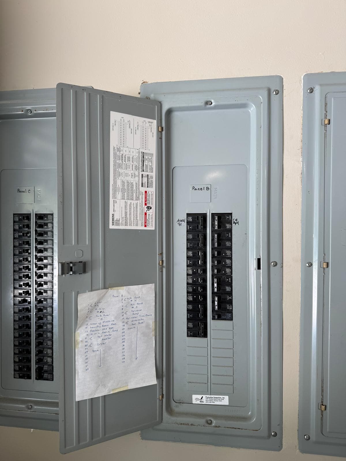 Open electrical panel with breakers individually labeled by circuit and room