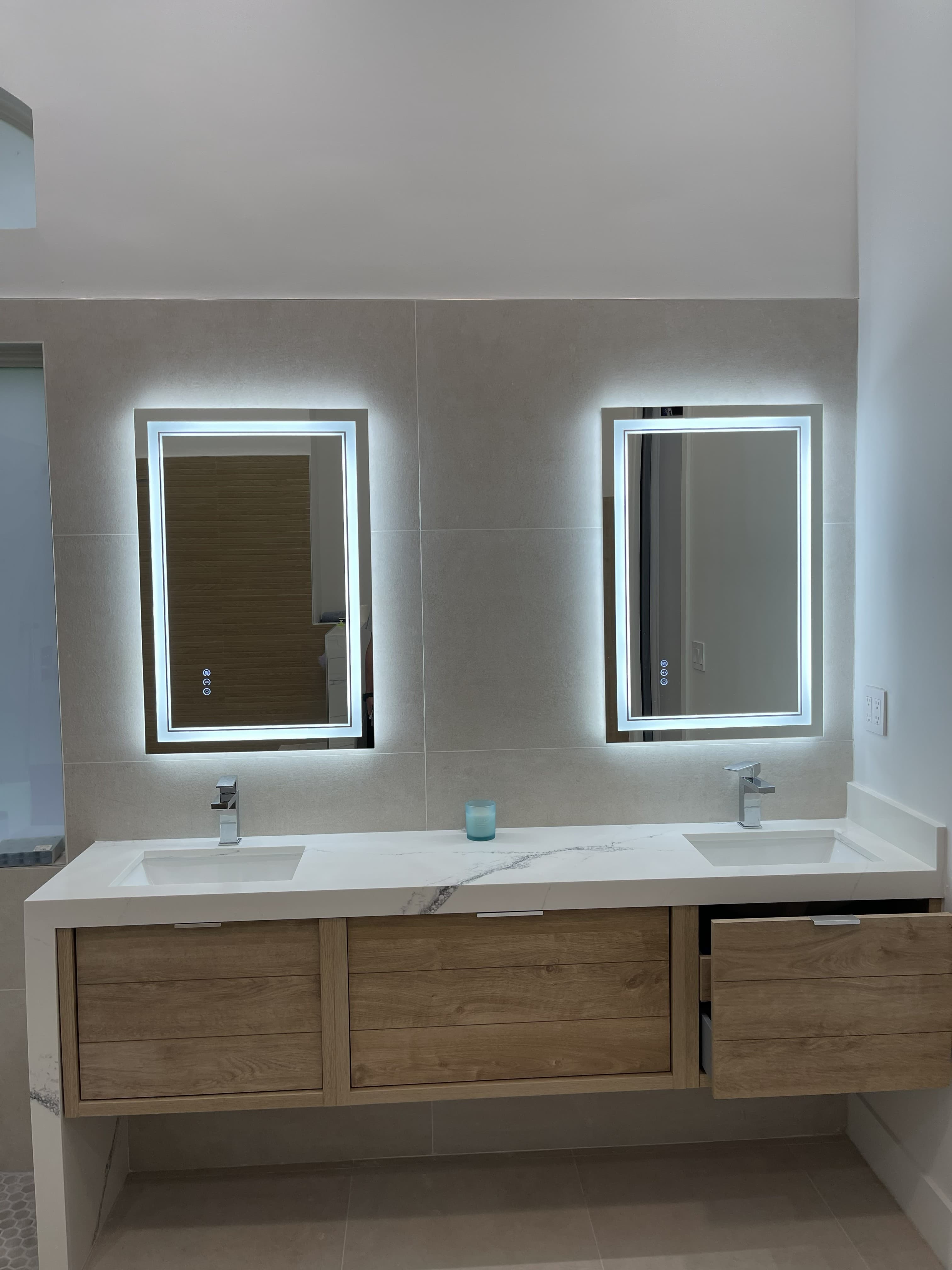 Residential bathroom vanity with illuminated mirrors