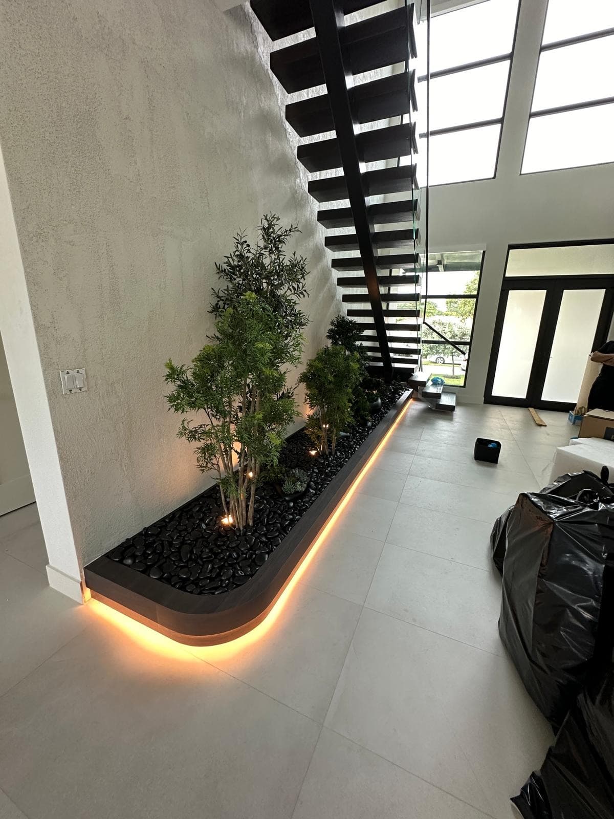Integrated landscape and accent lighting inside modern residence